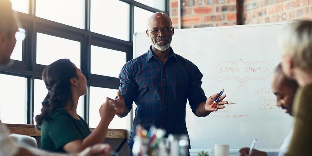 Coach discussing ideas with team
