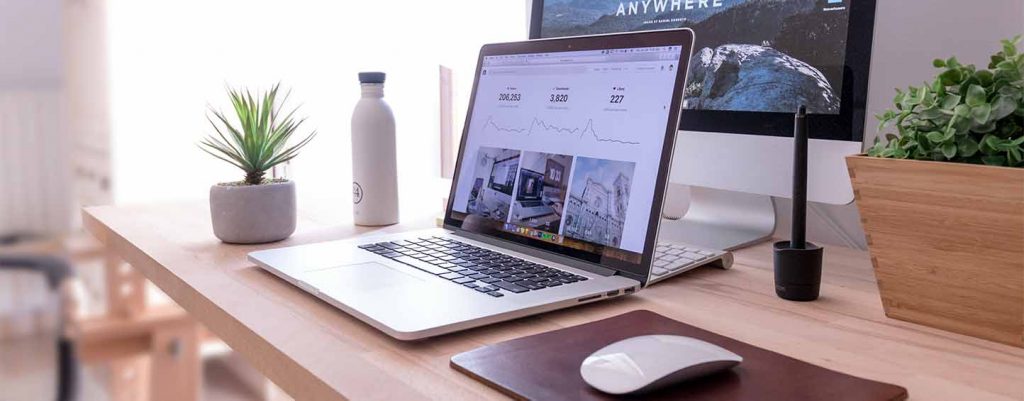 Laptop and desktop sitting on computer desk
